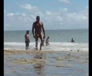 Bare guy with truly monster meaty pecker ambling beach